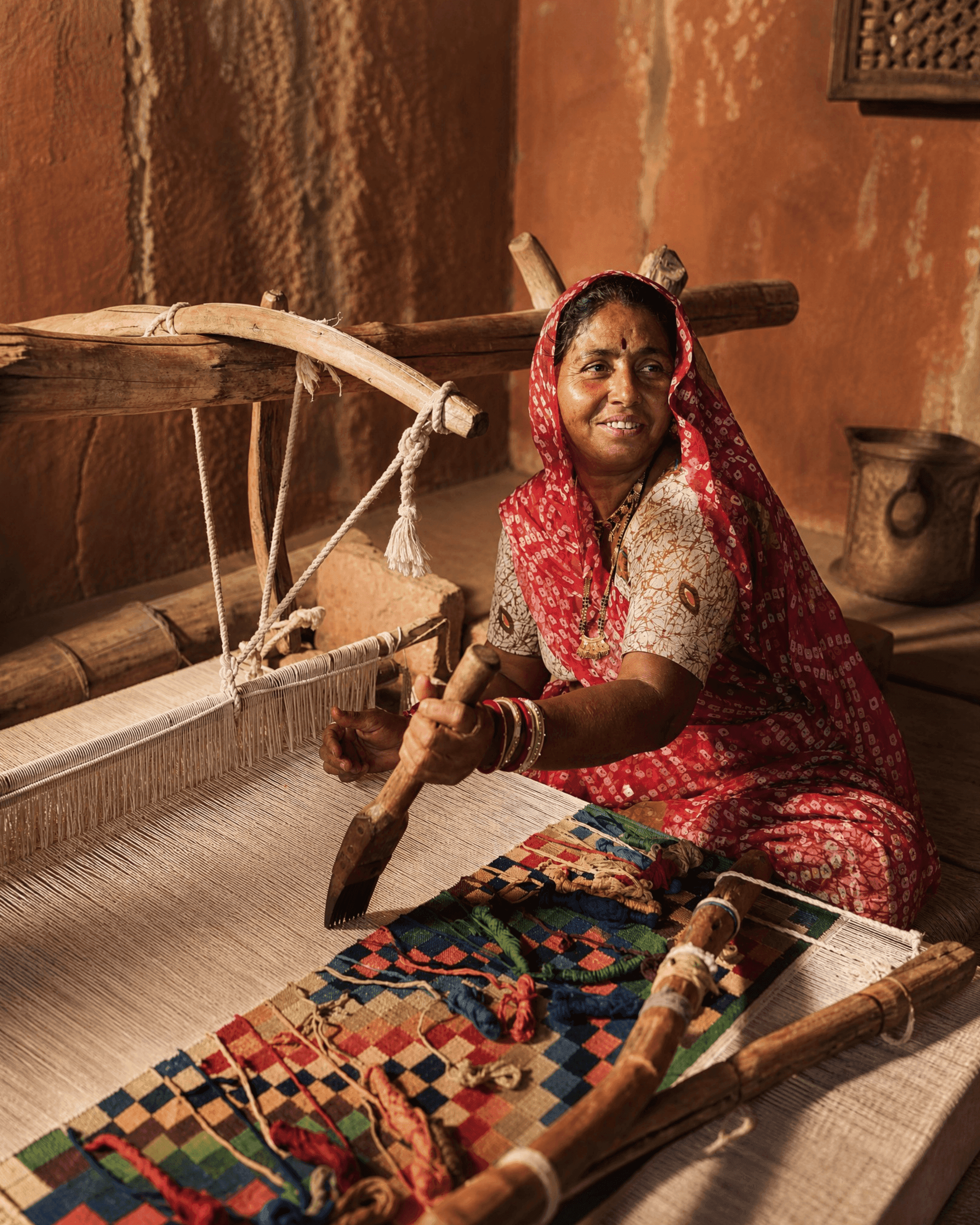 Master artisan hand weaving a bespoke luxury rug on a traditional loom